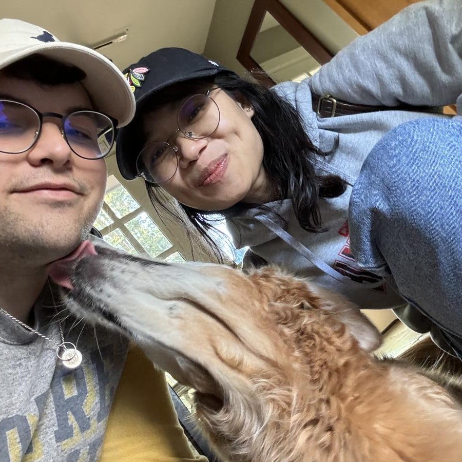 Jared and Ly taking a selfie with a golden dog