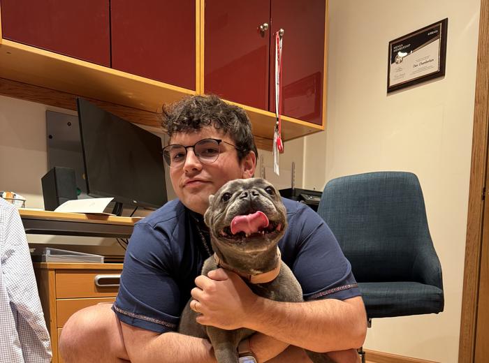 Sitting with a happy dog during a visit indoors